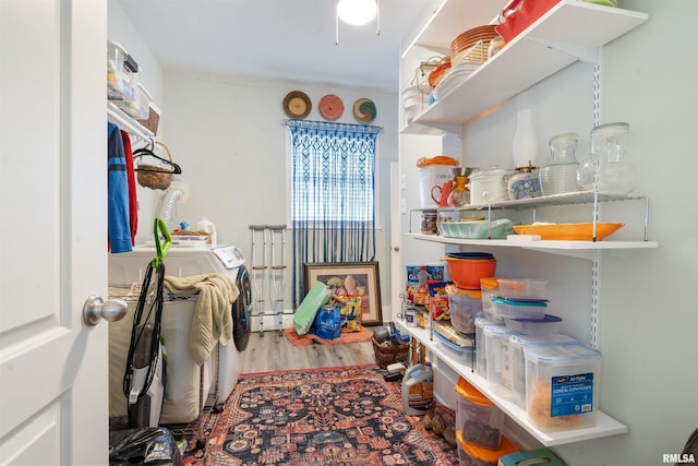 laundry room with washer and clothes dryer and hardwood / wood-style flooring