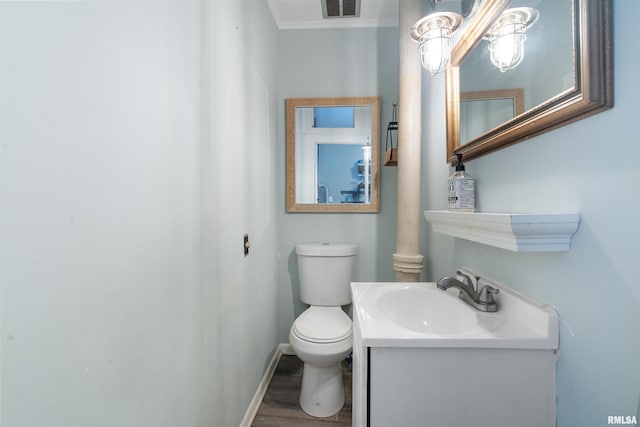 bathroom with vanity, toilet, and hardwood / wood-style flooring