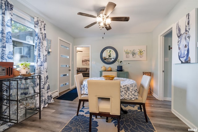 dining room with dark hardwood / wood-style flooring and ceiling fan