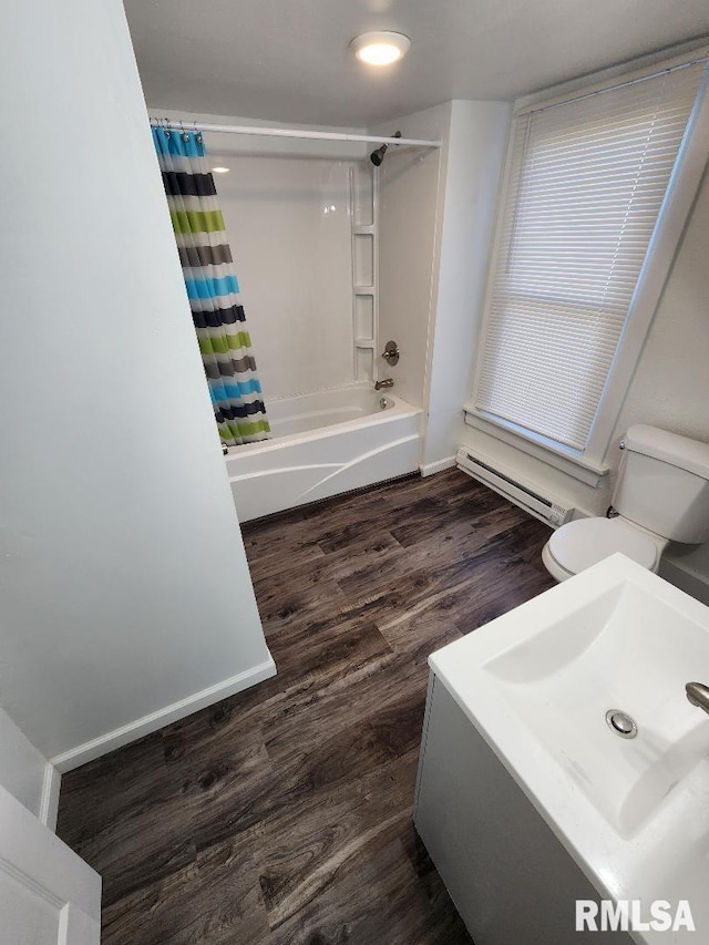 bathroom featuring wood-type flooring, shower / bathtub combination with curtain, a baseboard heating unit, and toilet