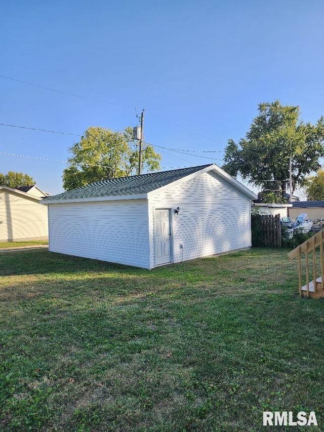 view of outbuilding with a yard