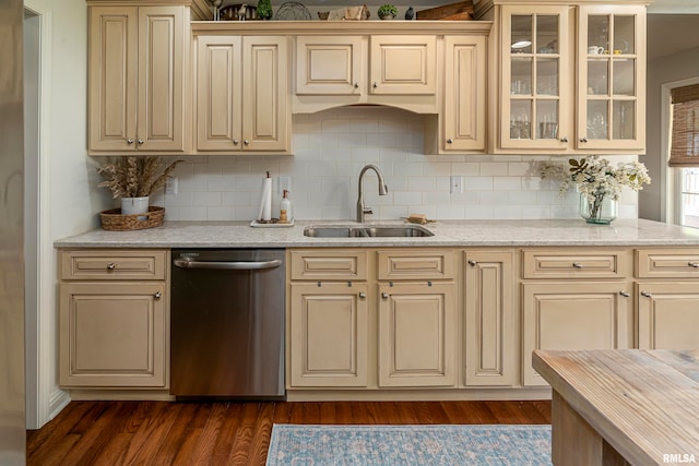 kitchen featuring cream cabinets, dark hardwood / wood-style floors, decorative backsplash, sink, and stainless steel dishwasher