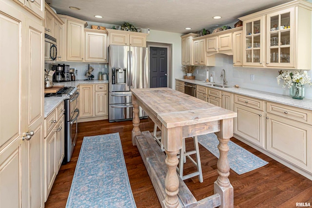 kitchen with decorative backsplash, sink, dark hardwood / wood-style floors, and stainless steel appliances