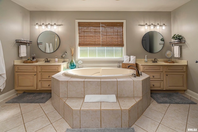 bathroom with tiled bath, tile patterned flooring, and vanity