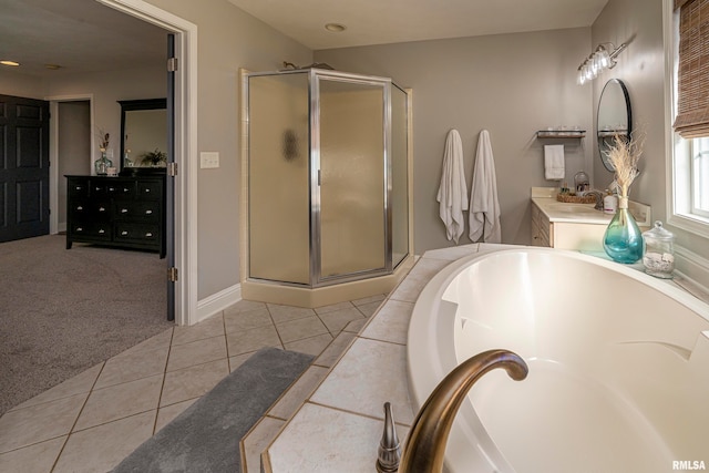 bathroom featuring vanity, a shower with shower door, and tile patterned floors