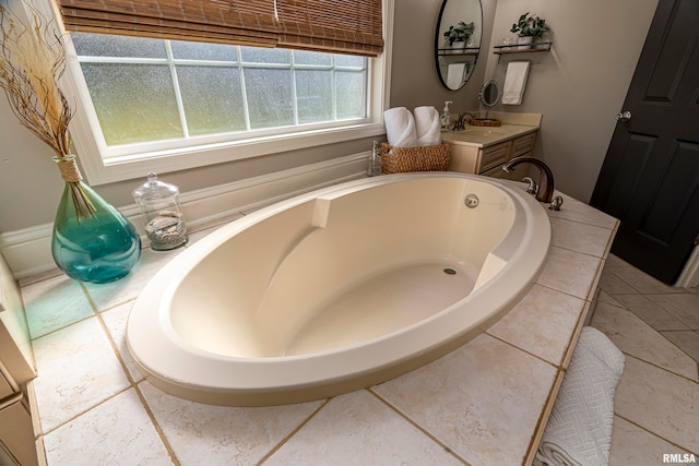 bathroom featuring a bathtub, vanity, and tile patterned floors