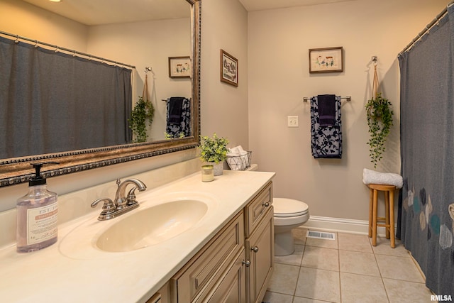 bathroom with vanity, tile patterned flooring, and toilet