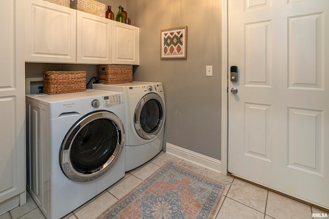 washroom featuring cabinets, independent washer and dryer, and light tile patterned floors