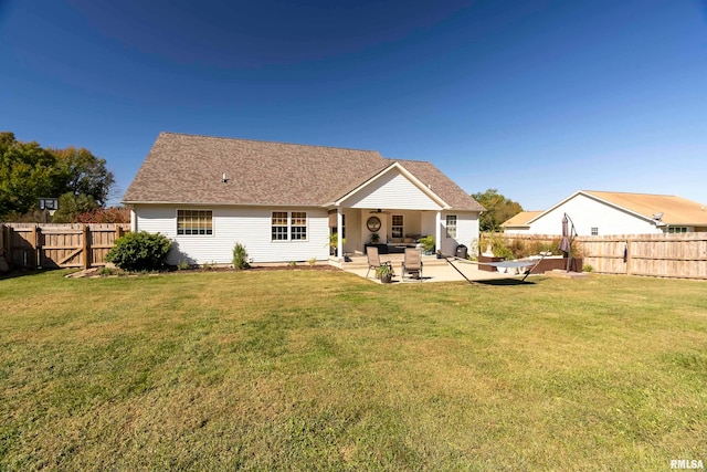 rear view of property with a patio area and a yard