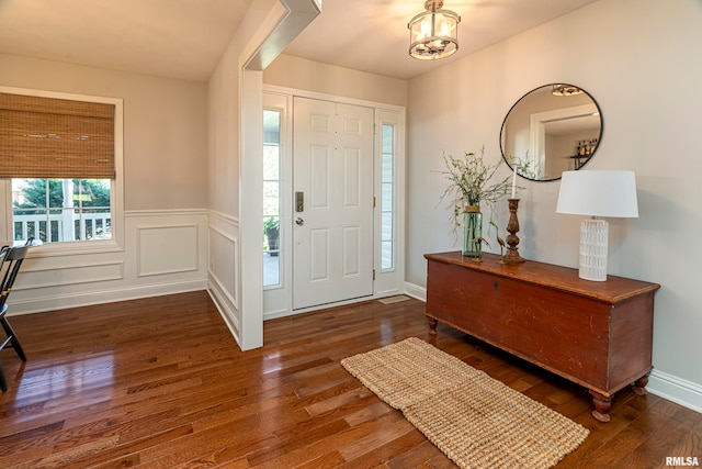 entrance foyer with dark wood-type flooring and a notable chandelier