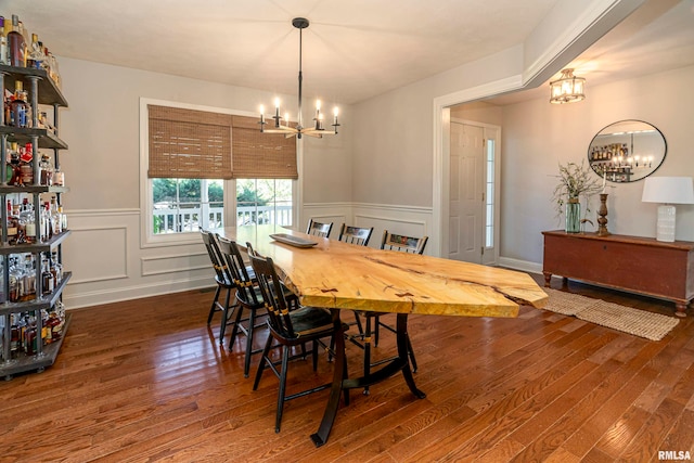 dining area featuring dark hardwood / wood-style flooring and a notable chandelier