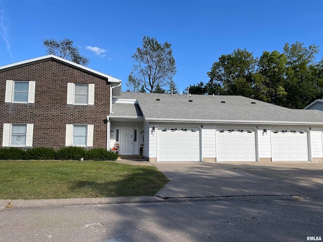 view of front of home with a garage and a front lawn