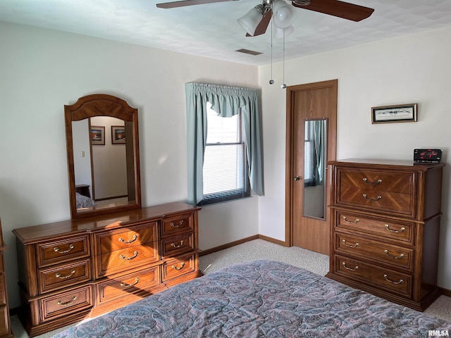 bedroom featuring ceiling fan and light carpet