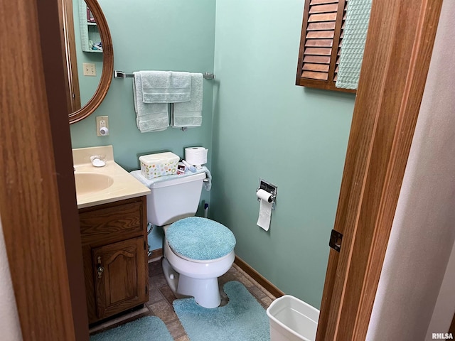 bathroom with vanity, tile patterned flooring, and toilet