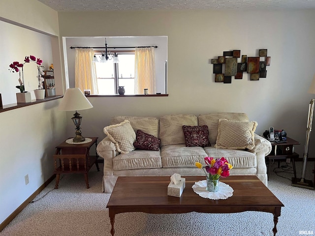 living room with a textured ceiling, a notable chandelier, and carpet flooring