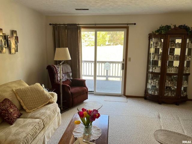 carpeted living room featuring a textured ceiling