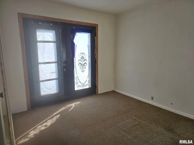 entryway with french doors and dark carpet