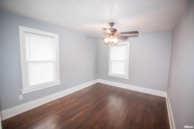 spare room featuring a textured ceiling, ceiling fan, and dark hardwood / wood-style flooring