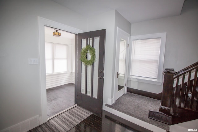 foyer entrance with dark hardwood / wood-style floors