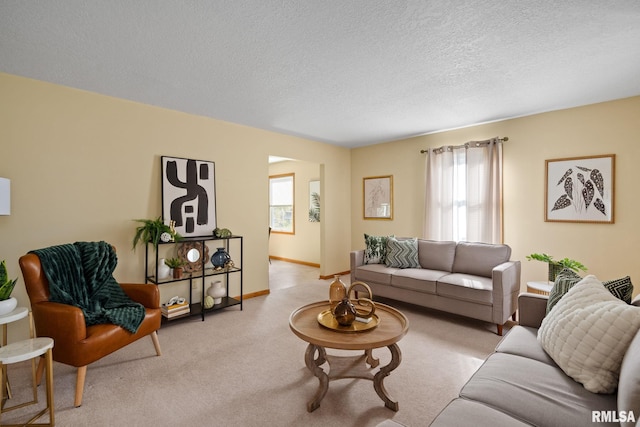 living room featuring light carpet and a textured ceiling