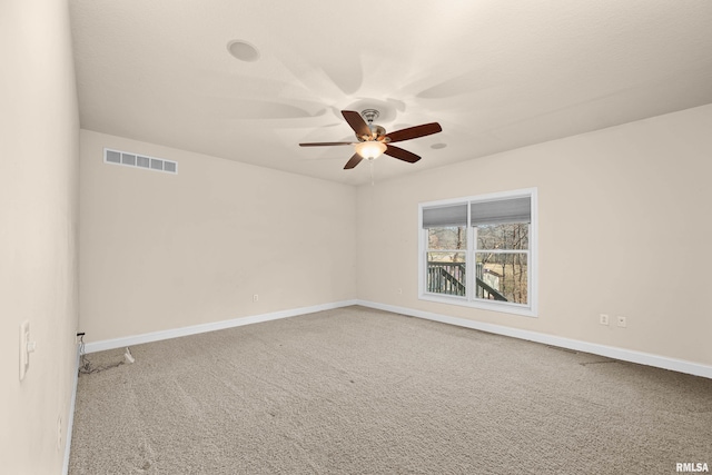 carpeted empty room featuring ceiling fan