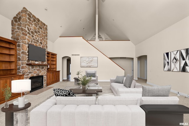 living room featuring light carpet, a fireplace, beamed ceiling, and high vaulted ceiling