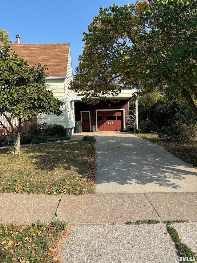 view of front of home with a front yard, a garage, and a carport