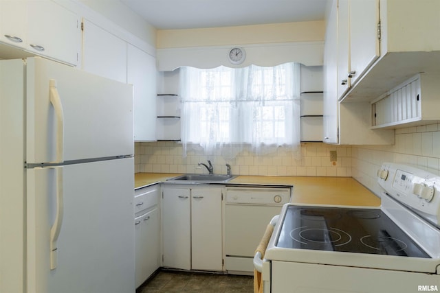 kitchen with white appliances, sink, and white cabinets