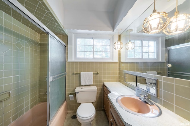 full bathroom with vanity, tile walls, and toilet