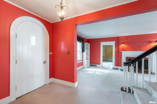 foyer entrance featuring light colored carpet and crown molding