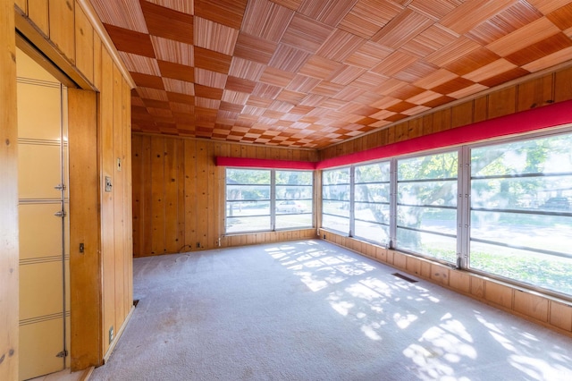 unfurnished sunroom with wood ceiling