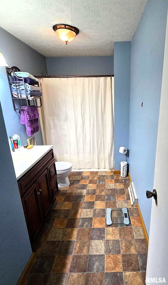 bathroom with a shower with curtain, vanity, toilet, and a textured ceiling