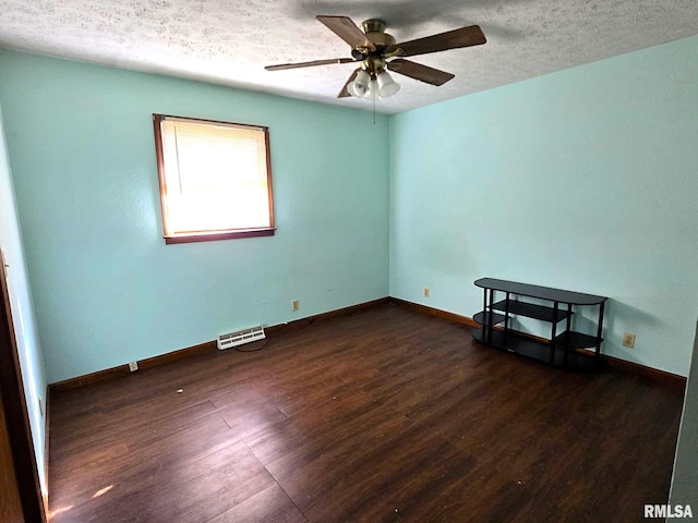 empty room with ceiling fan, a textured ceiling, and dark hardwood / wood-style flooring