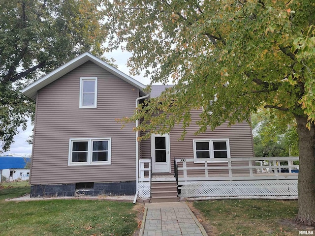 rear view of house with a yard and a deck