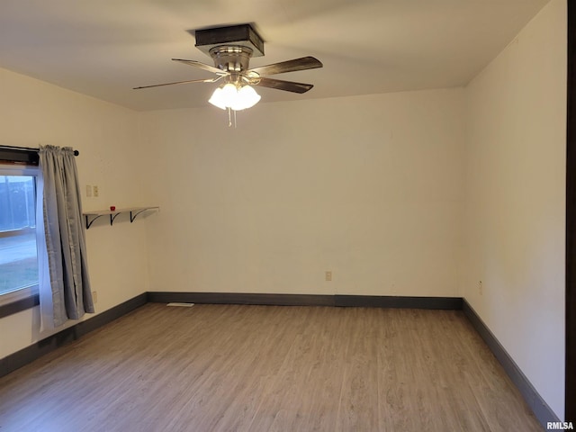 empty room featuring light wood-type flooring and ceiling fan