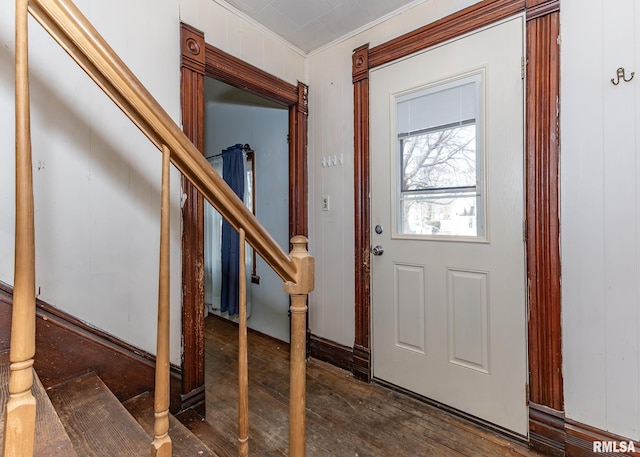 entryway featuring stairs, dark wood-type flooring, and ornamental molding