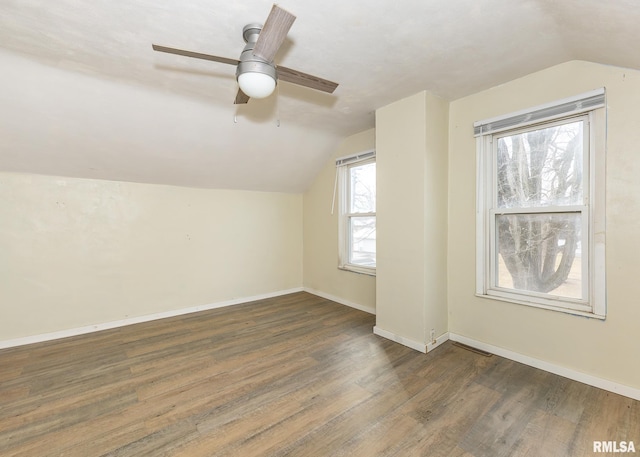 bonus room with dark wood-style floors, lofted ceiling, ceiling fan, and baseboards