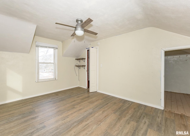 additional living space with lofted ceiling, ceiling fan, baseboards, and wood finished floors