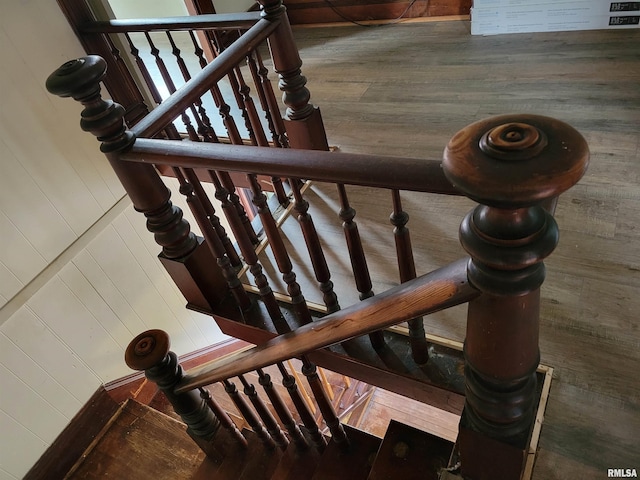 stairs featuring wooden walls