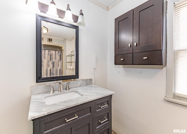 full bath featuring ornamental molding and vanity