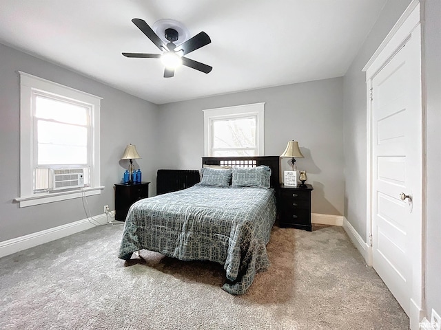 carpeted bedroom with ceiling fan and cooling unit