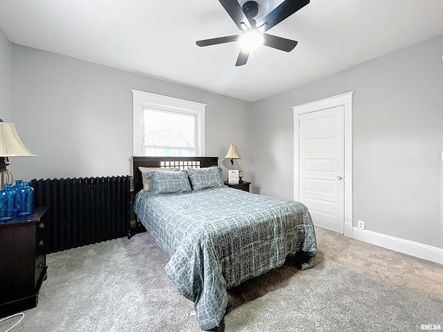 carpeted bedroom with ceiling fan and radiator heating unit