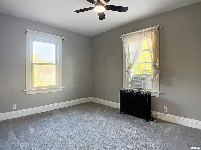 carpeted spare room with ceiling fan, cooling unit, and radiator