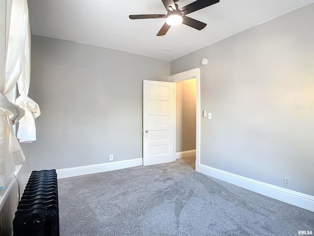 unfurnished bedroom featuring ceiling fan and carpet floors