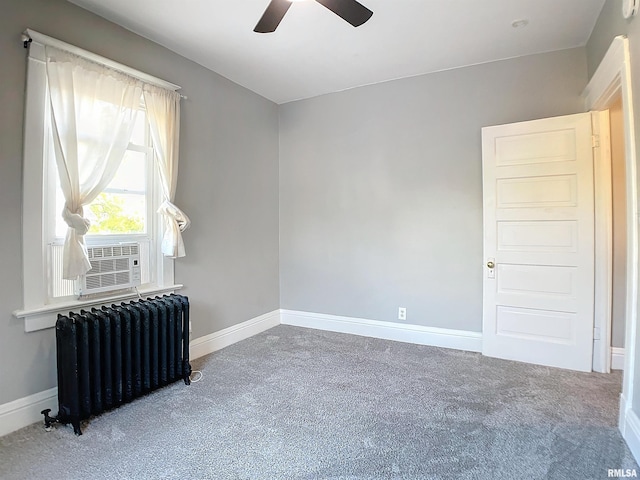 carpeted empty room with ceiling fan, radiator heating unit, and cooling unit