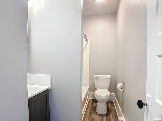 bathroom featuring vanity, wood-type flooring, and toilet