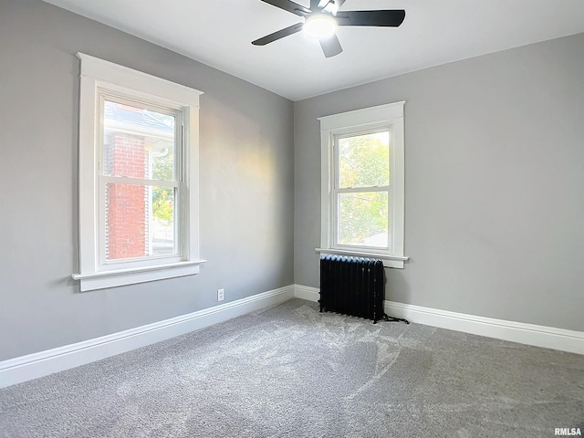 carpeted spare room with ceiling fan and radiator heating unit