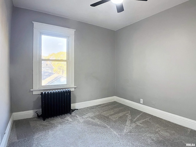 spare room with carpet flooring, ceiling fan, and radiator heating unit