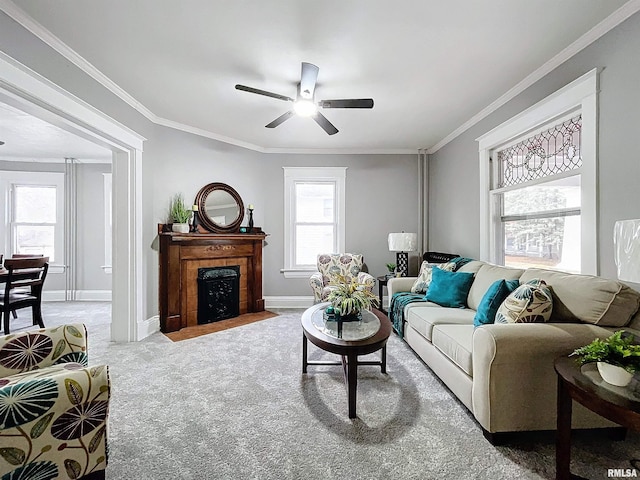 carpeted living room featuring ceiling fan and ornamental molding