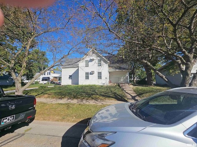 view of front of house featuring a front yard and a garage